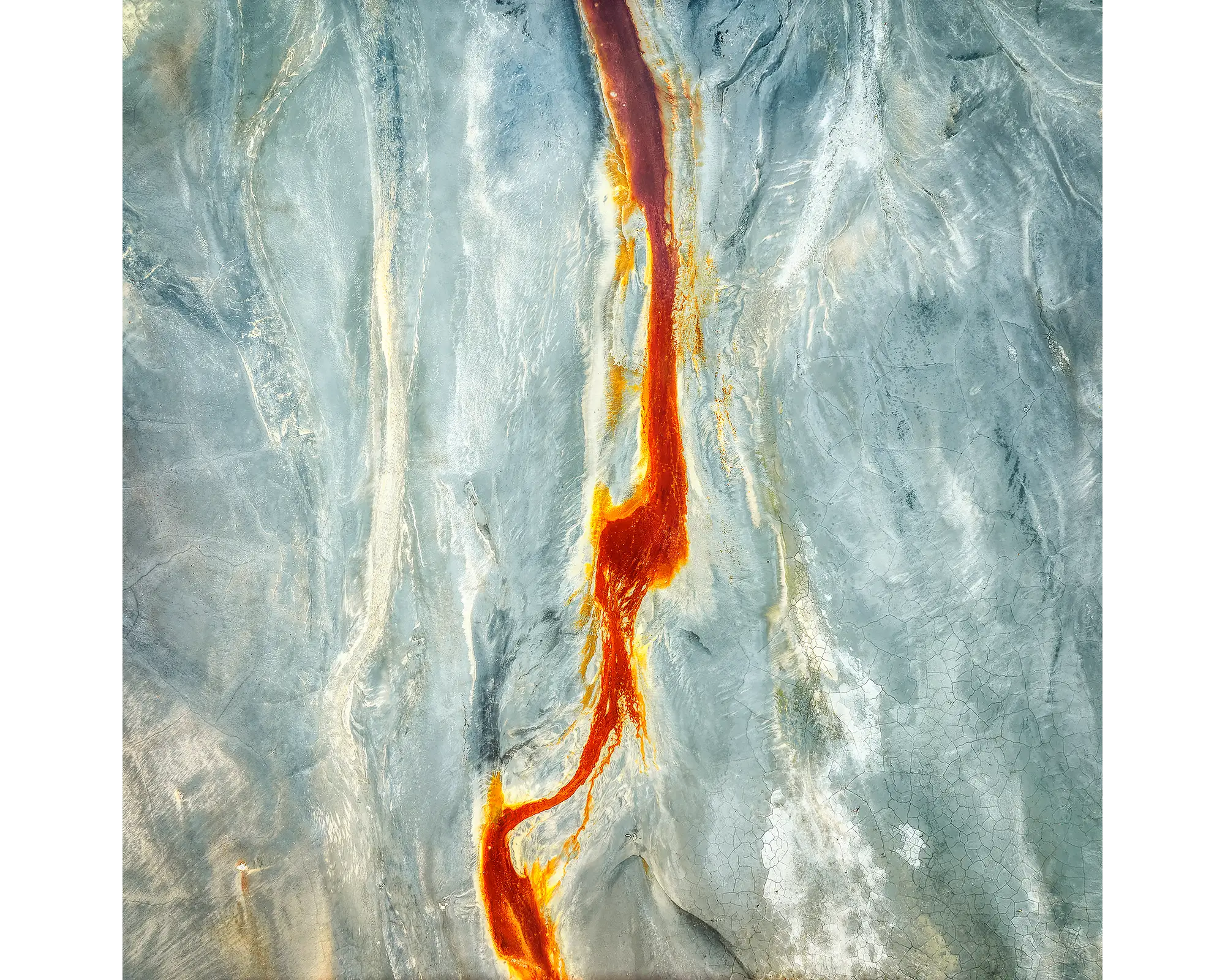 Aerial view of a dried out dam with a red line down the middle, NSW. 