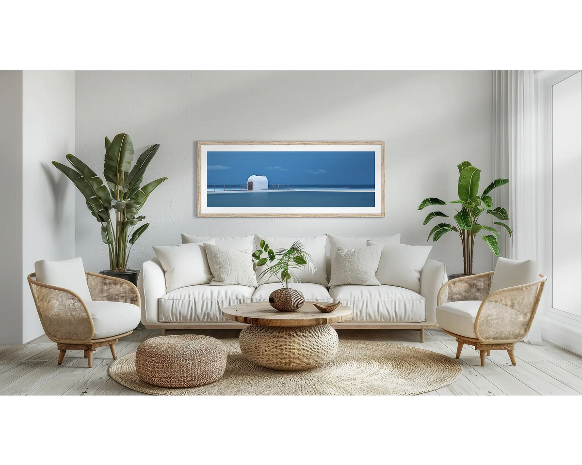 Merewether Calm. Newcastle wall art print, with a Tassie oak frame, above a couch. 