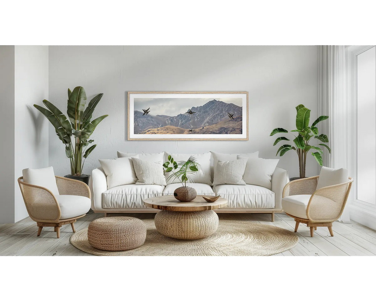 Mountain Bomb Burst. Aviation wall art print, with a Tassie oak frame, above a couch. 