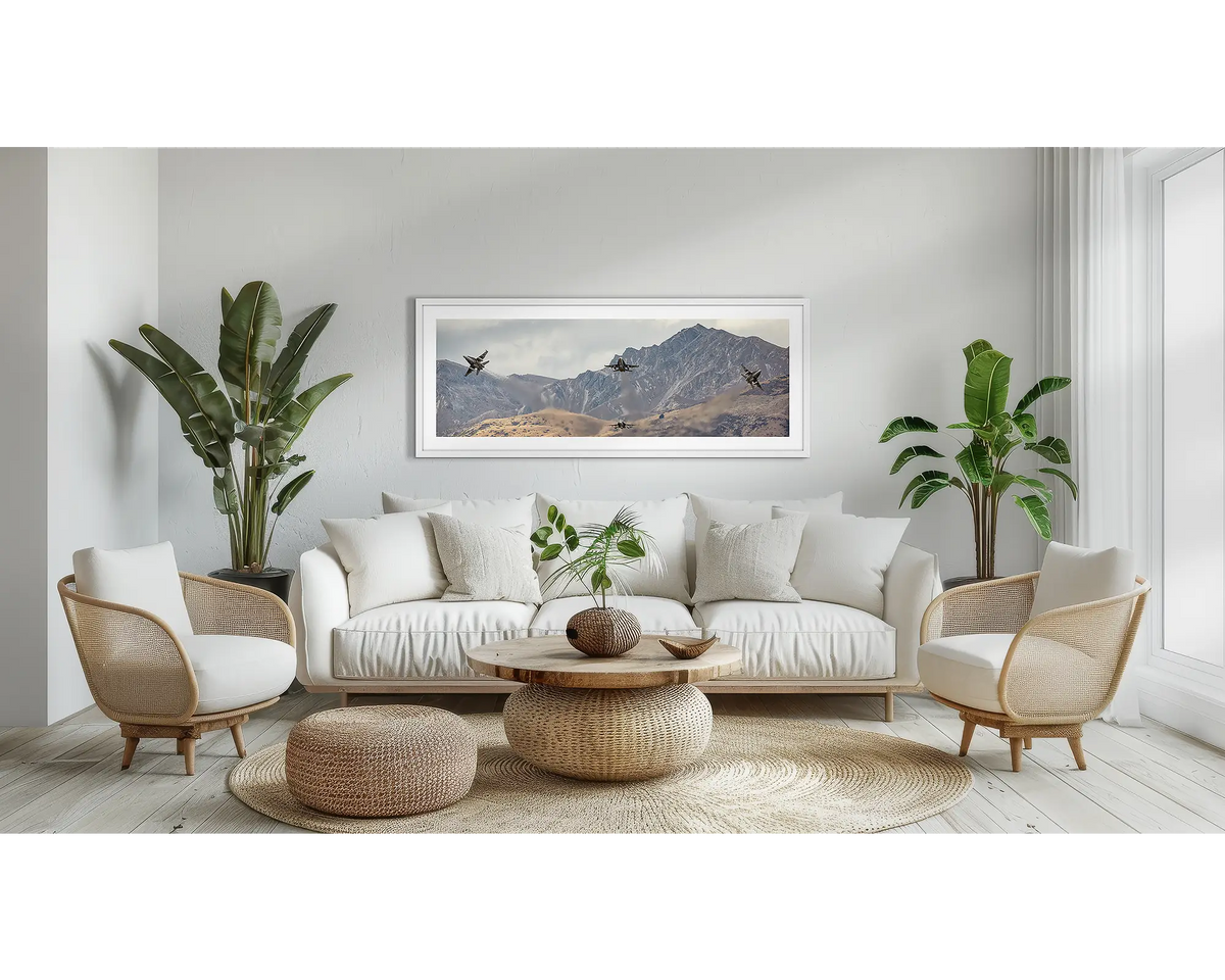 Mountain Bomb Burst. Aviation wall art print, with a white frame, above a couch. 