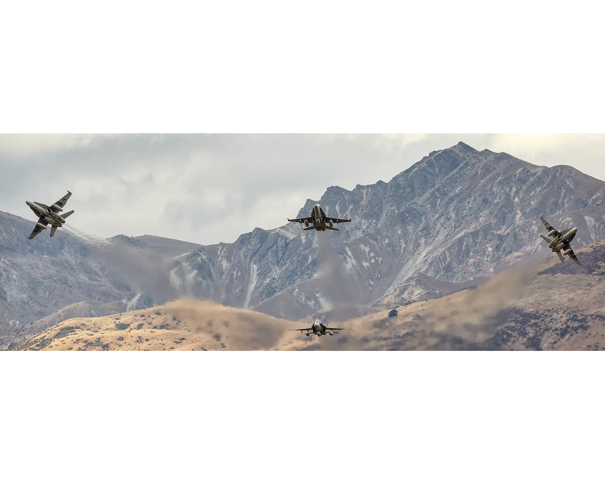 Royal Australian Air Force 3 squadron F/A-18 Hornets flying in front of a mountain range in New Zealand. 