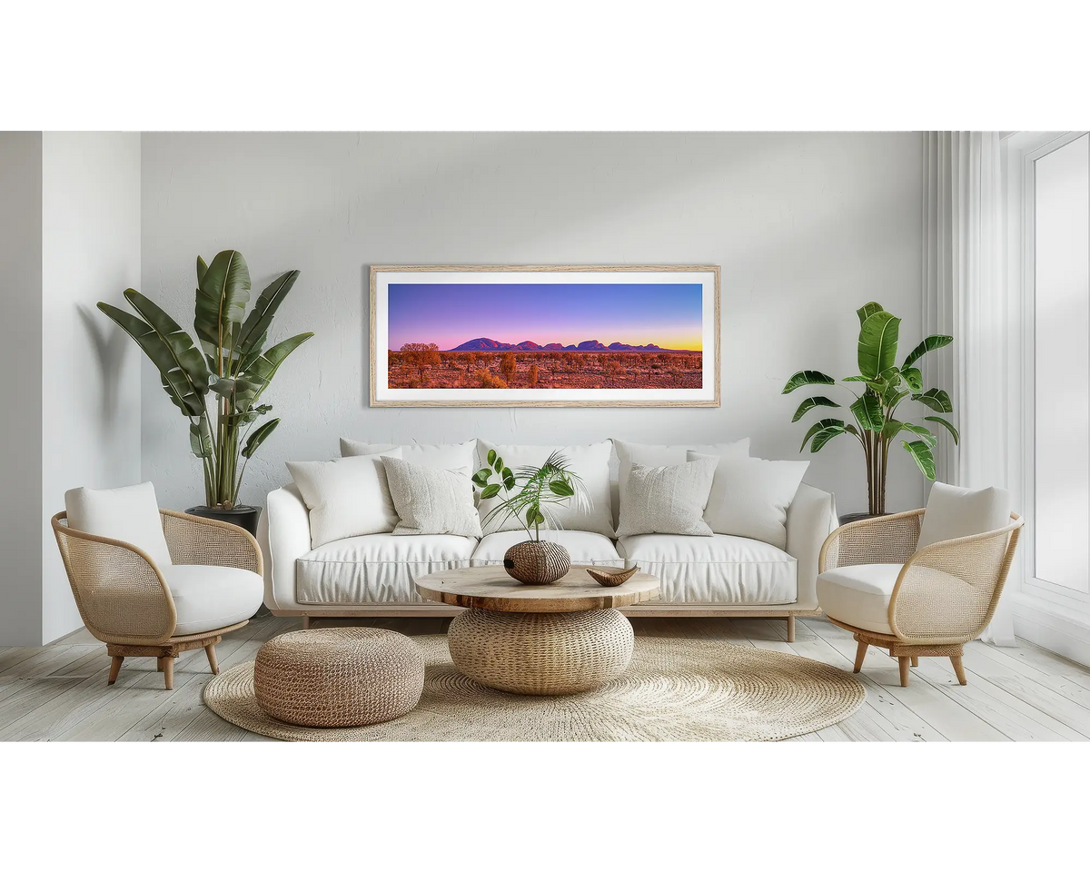 Natural Wonder. Outback sunrise wall art print, with a Tassie Oak frame, above a couch. 