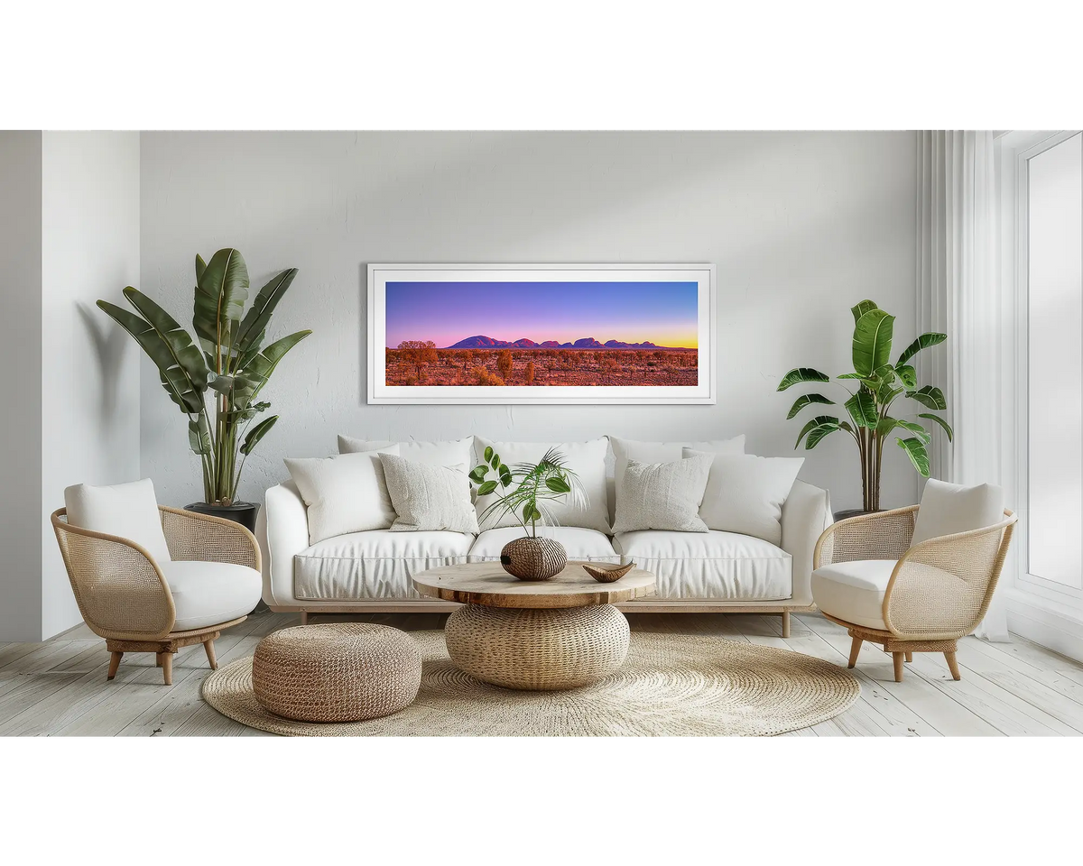 Natural Wonder. Outback sunrise wall art print with a white frame, above a couch. 