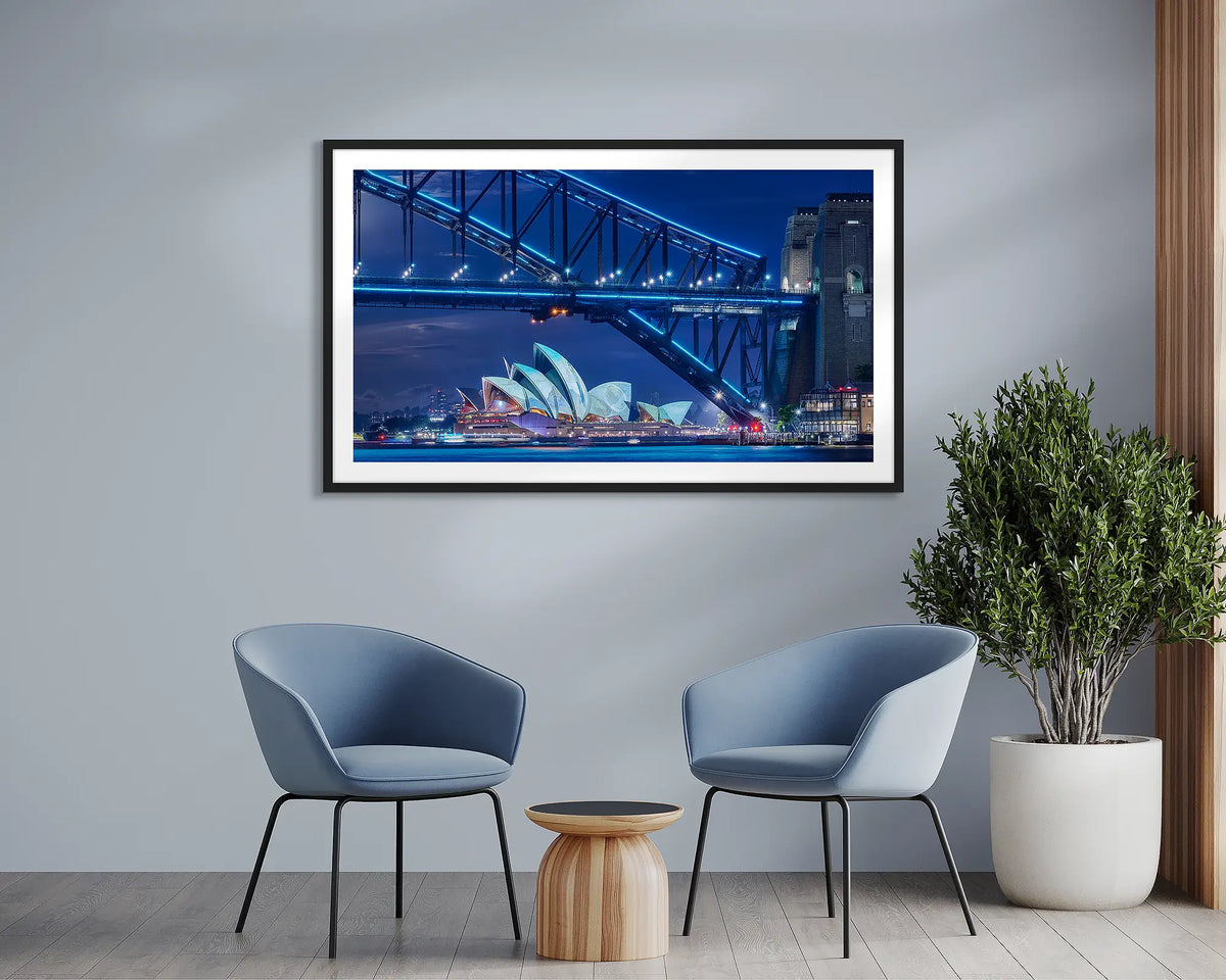 Neon. Sydney framed wall art print, with a black frame, in a meeting room. 