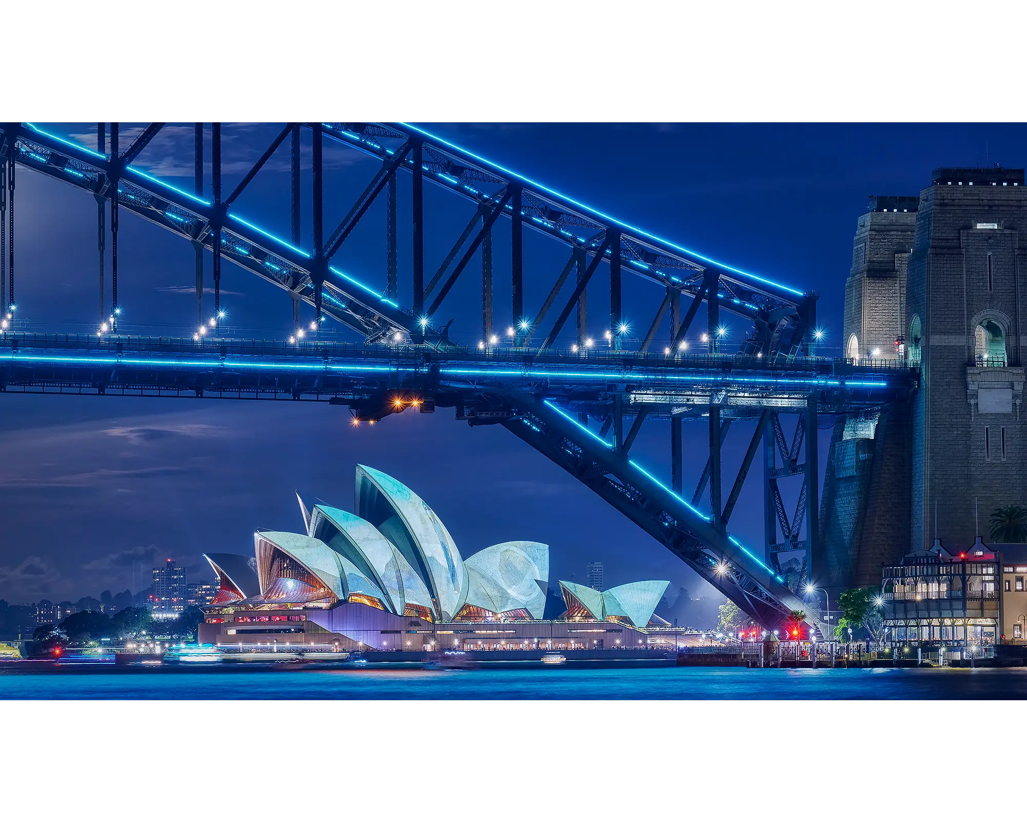 Sydney Harbour Bridge and Sydney Opera House lit up during Vivid Sydney.