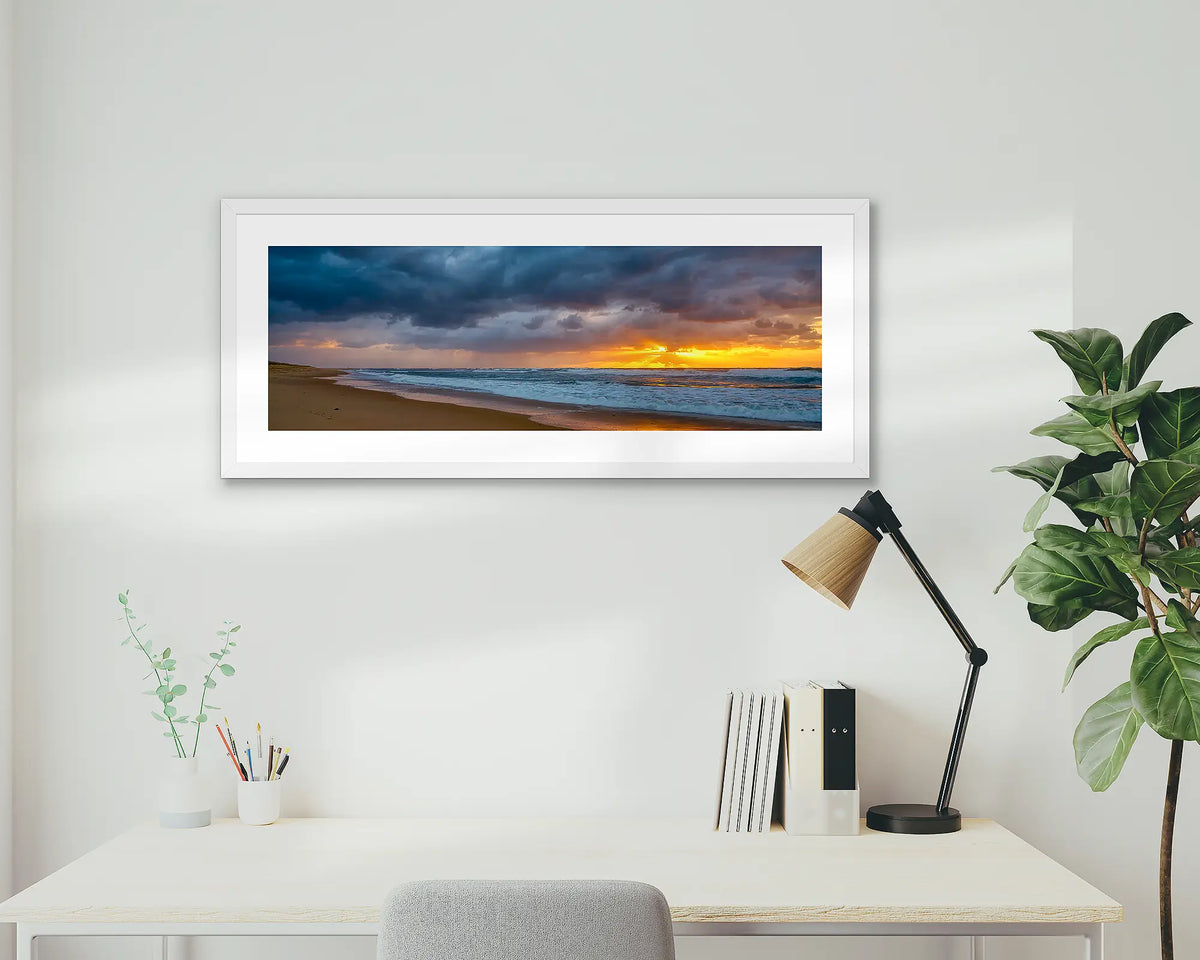 Newcastle Awakening. Framed coastal wall art print, in a white frame, of Nobbys beach at sunrise. 