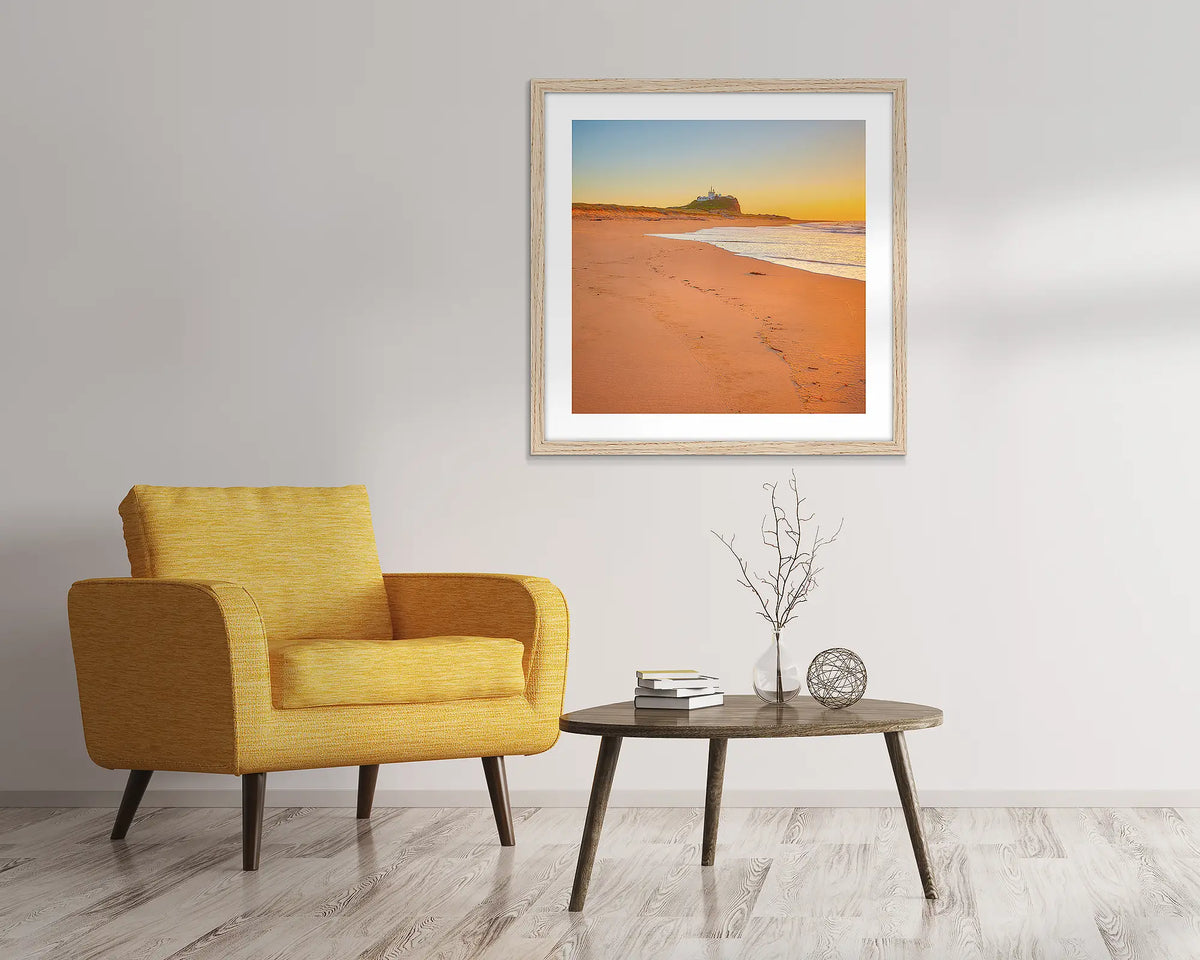 Newcastle Nostalgia. Nobbys beach sunrise, framed wall art print with a wood frame, in an entry foyer. 