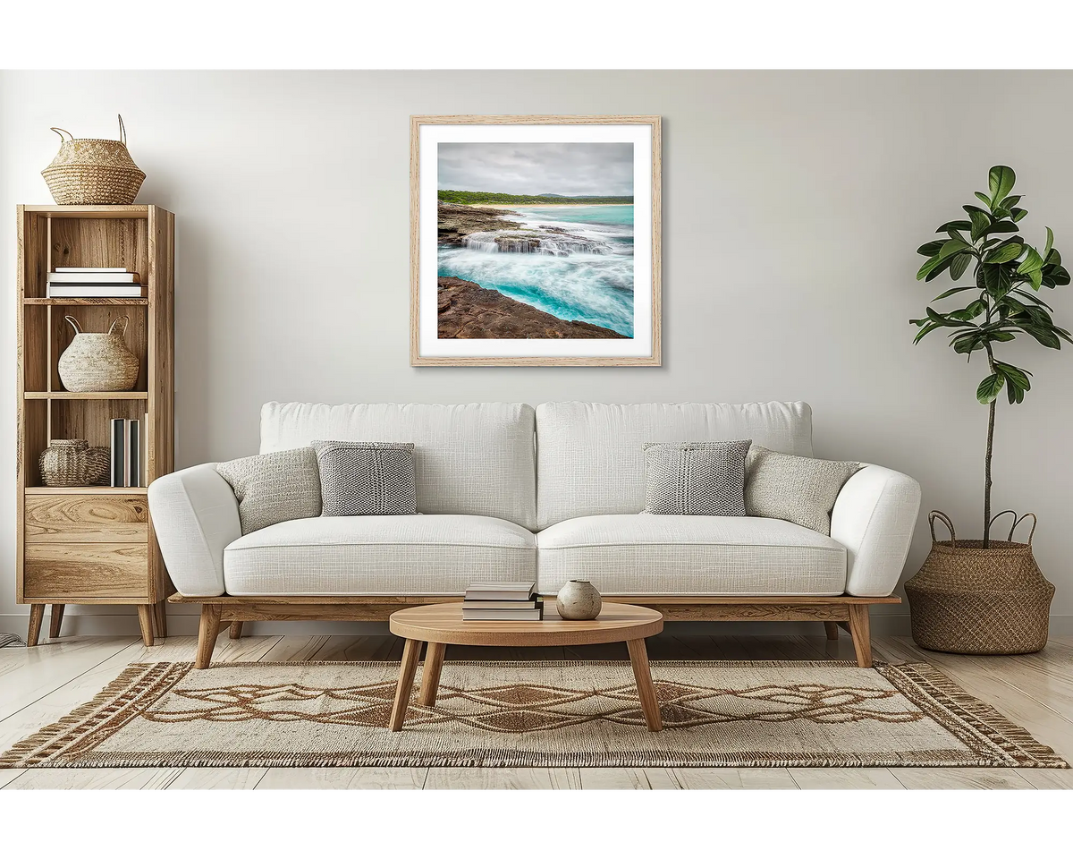 On the Rocks. South Durras wall art, with a timber frame, in a lounge room, above a couch. 