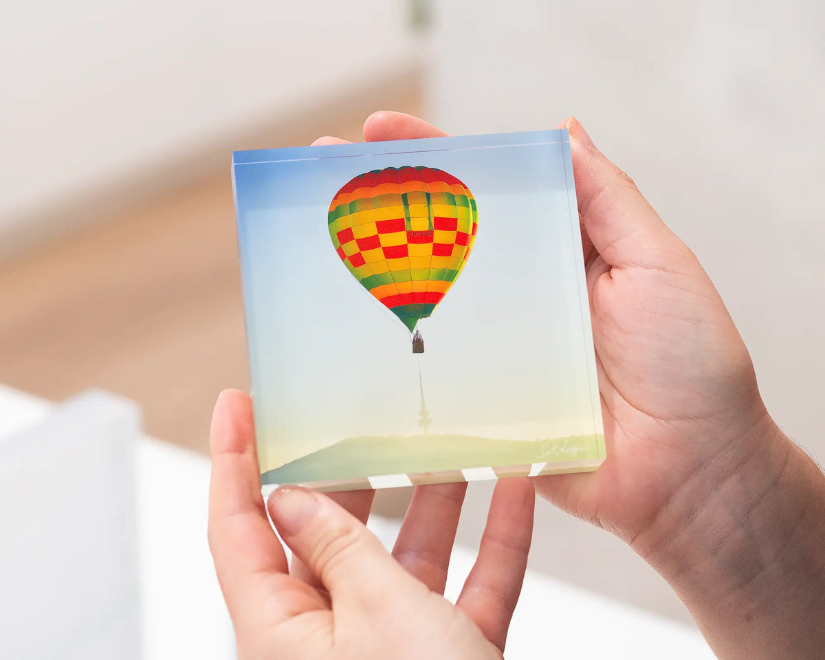 On Top acrylic block being held. 