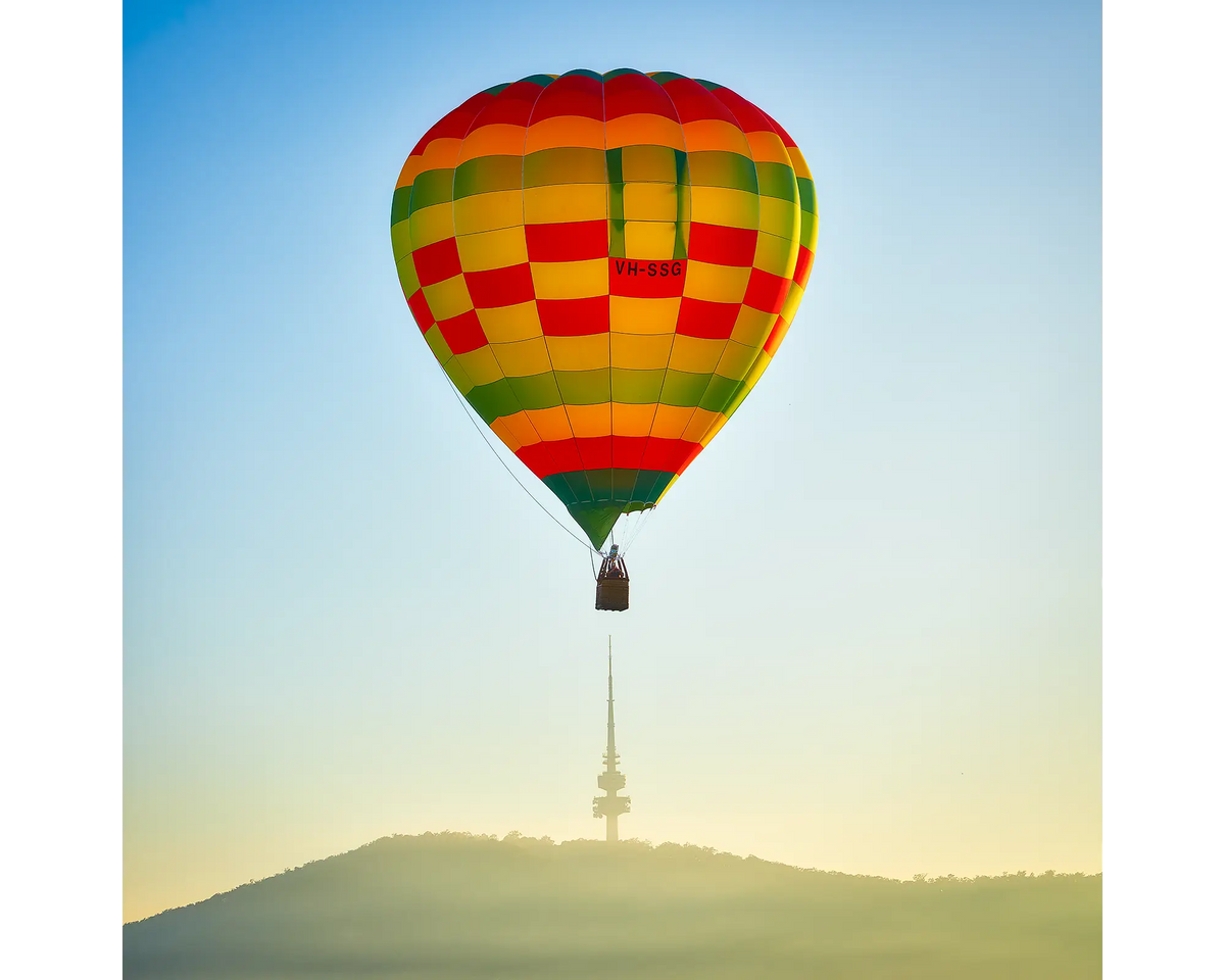 Hot air balloon flying over Black Mountain Tower, Canberra, ACT. 