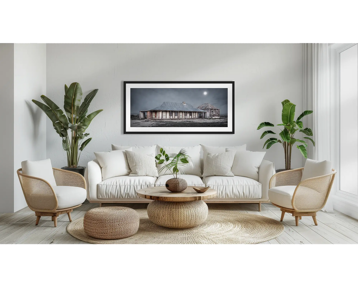 One Tree Hotel. Outback hotel wall art print, with a black frame, above a couch. 