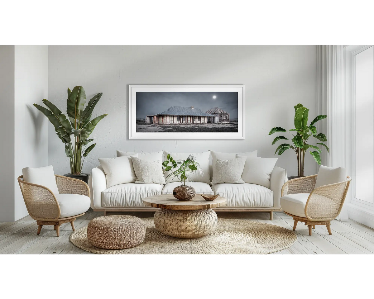 One Tree Hotel. Outback hotel wall art print, with a white frame, above a couch. 