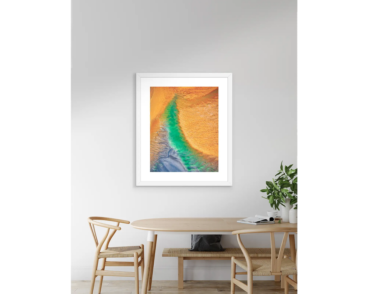 Opal Illusion - abstract artwork with white frame, hanging above table.