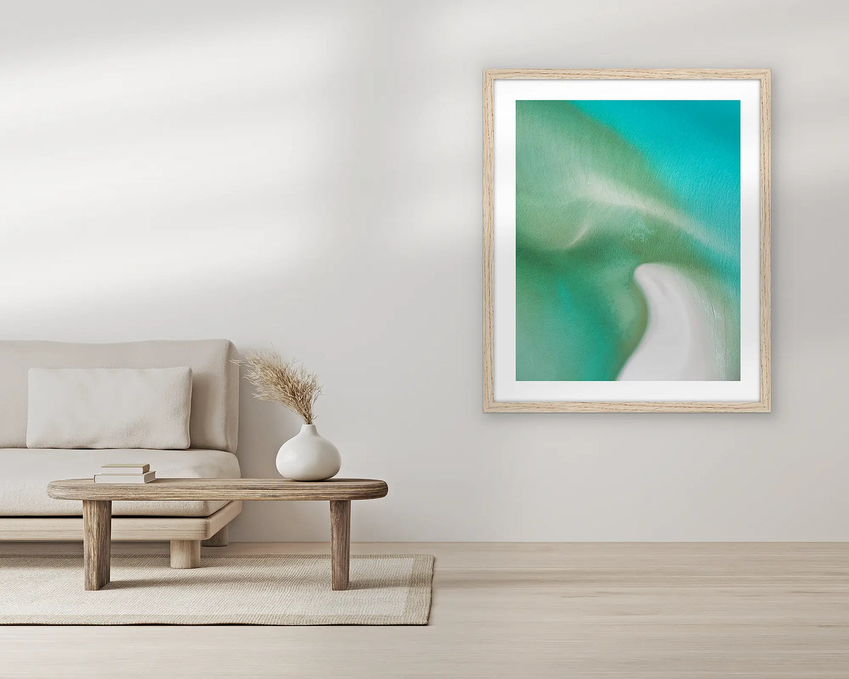 Opal Waters. Extra large wall art print, with a Tassie oak frame, in a living room. 