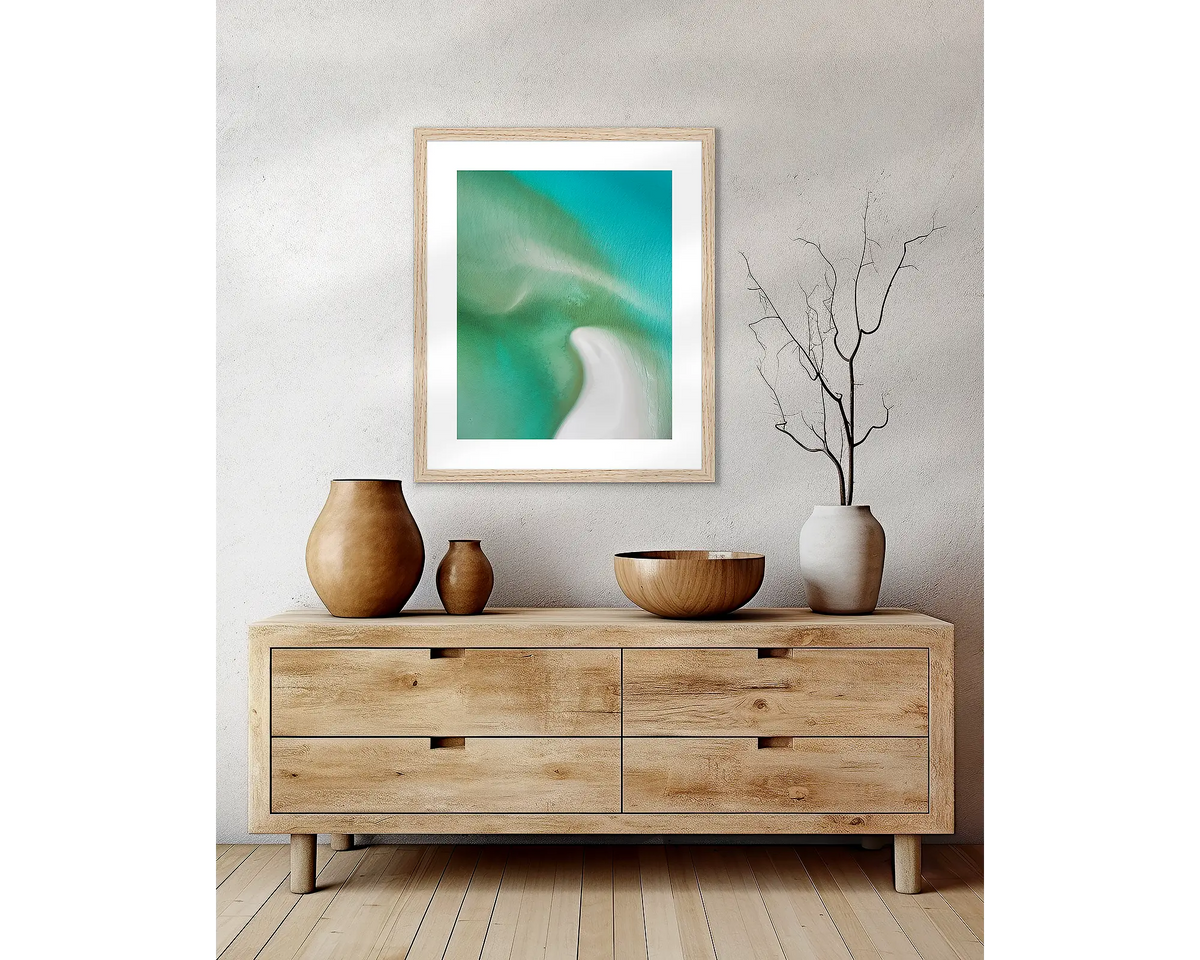 Opal Waters. Framed coastal wall art hanging above a side table.