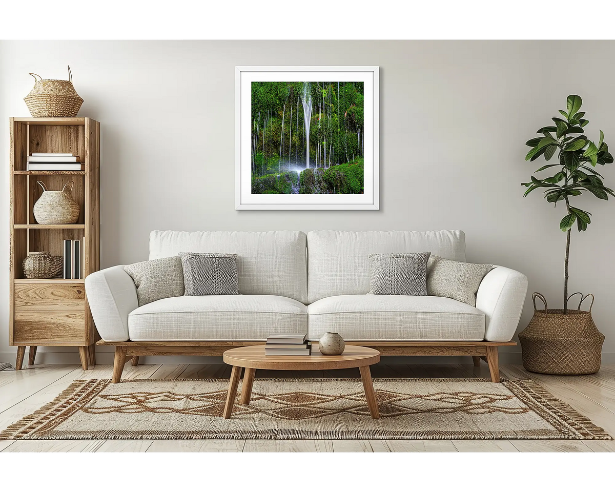 Otway Flow. Waterfall wall art with a white frame, in a lounge room, above a couch. 