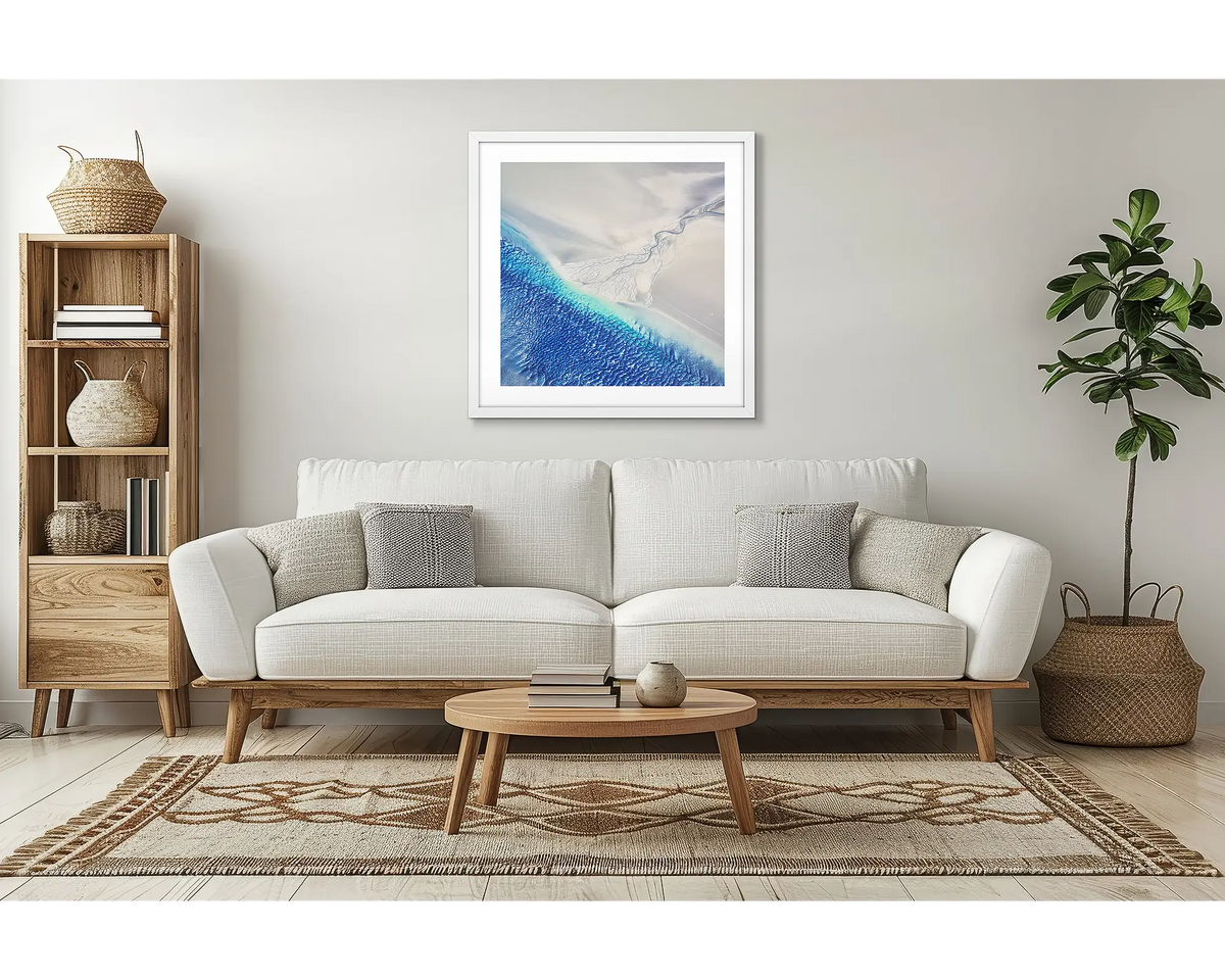 Outlet. Abstract artwork with a white frame, in a lounge room, above a couch. 