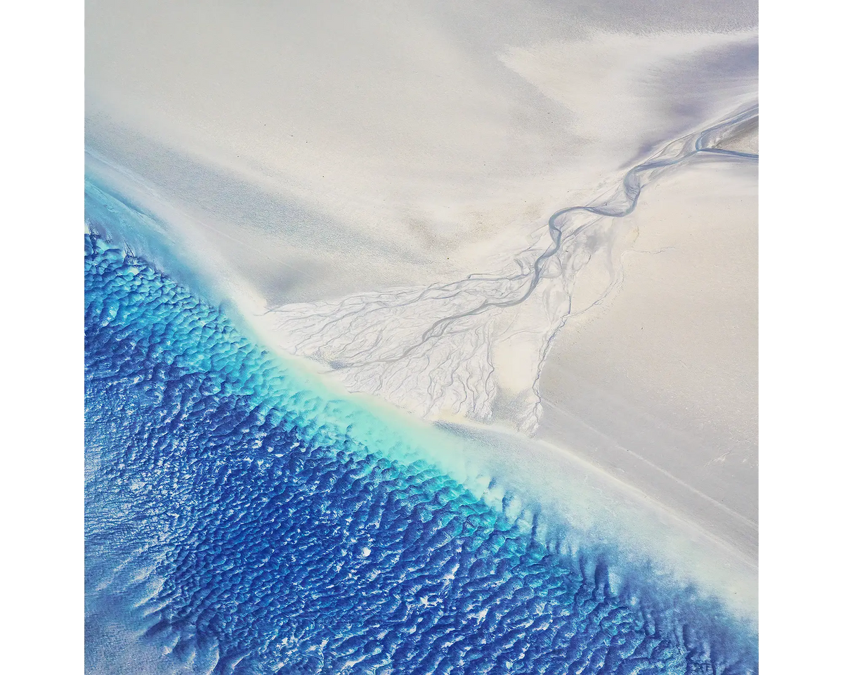 Blue water and white sand seen from above at Roebuck Bay, West Kimberley region, WA. 