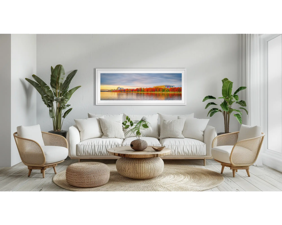 Outlook. Canberra sunrise wall art print, with a white frame, above a couch. 