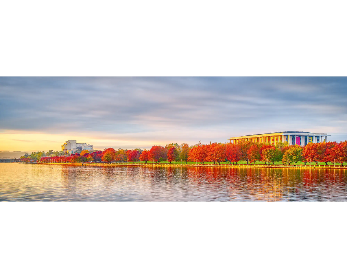 Sunrise with autumn trees beside Lake Burley Griffin, with the National Library and the High Court of Australia in the background, Canberra, ACT. 