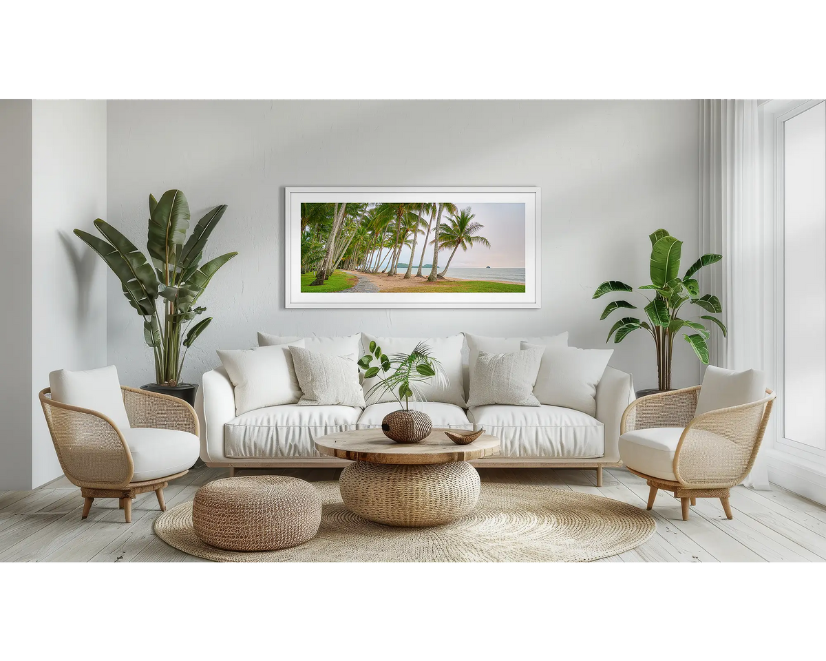 Palm Tree Tunnel. Queensland wall art print, with a white frame, above a couch.