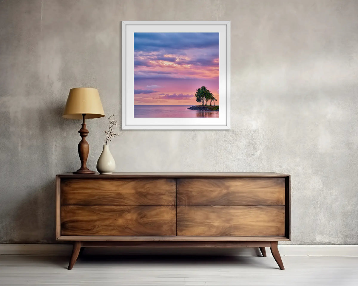 Paradise Palms. Square, tropical wall art print, with a white frame, above a side table.