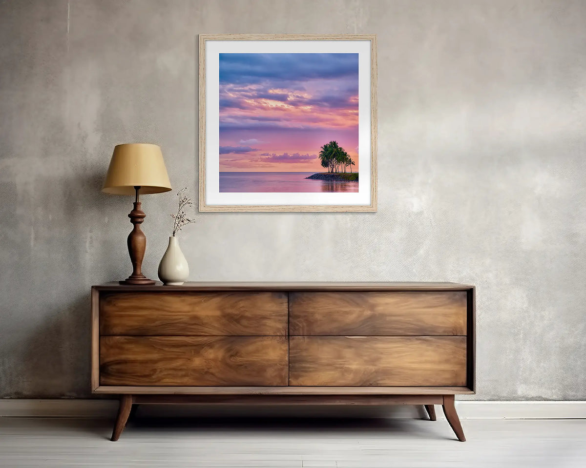 Paradise Palms. Square, tropical wall art print, with a wood frame, above a side table.