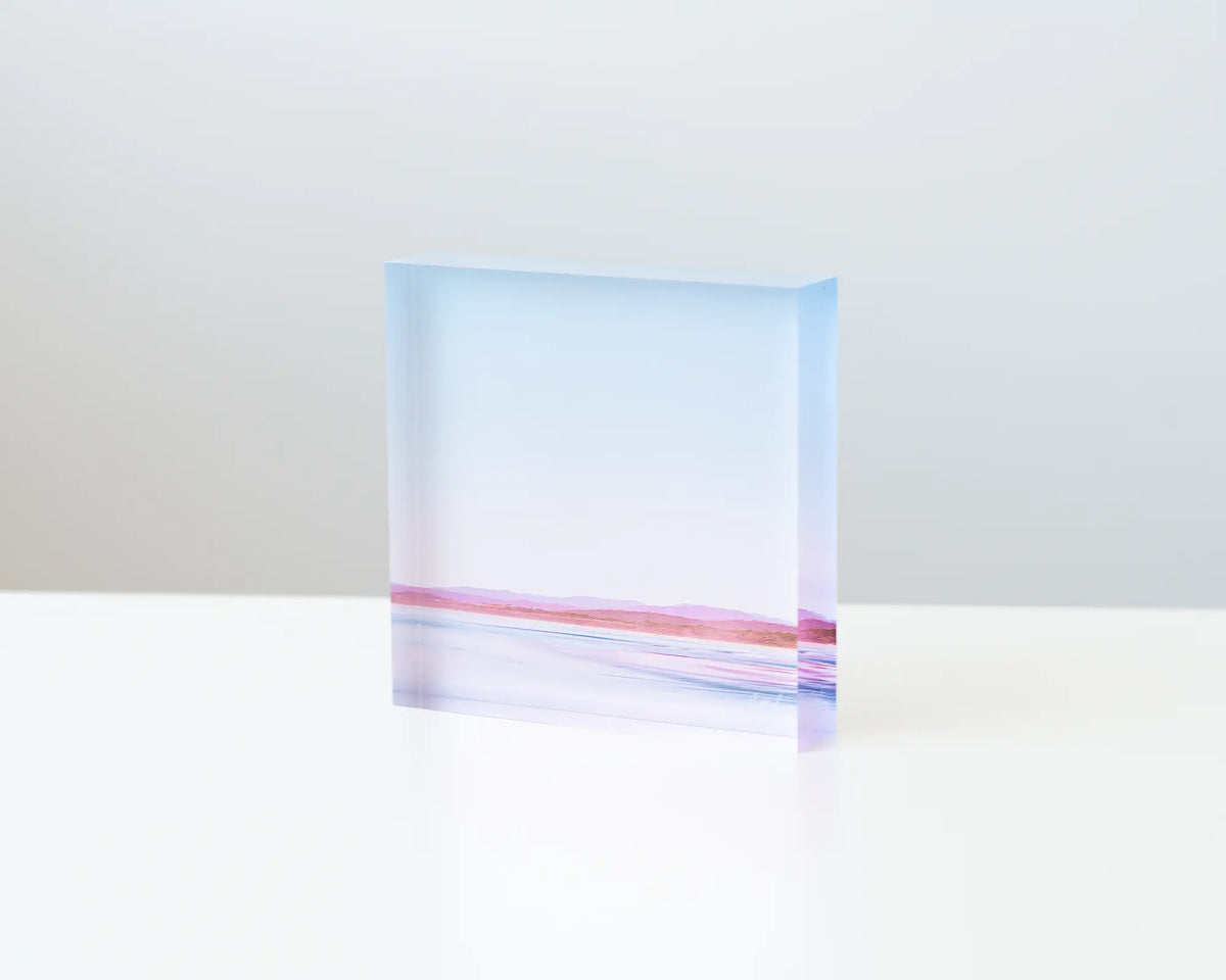 Perspective acrylic block displayed on a desk. 