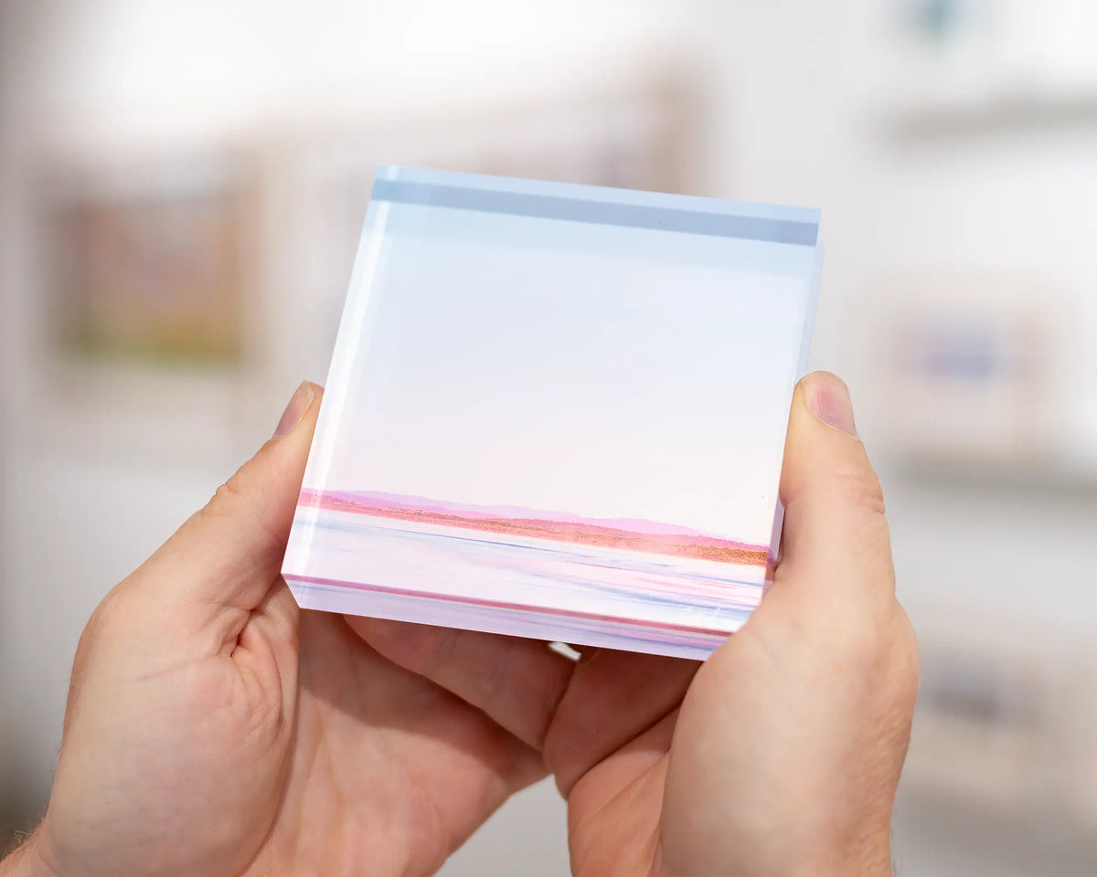 Perspective acrylic block being held. 