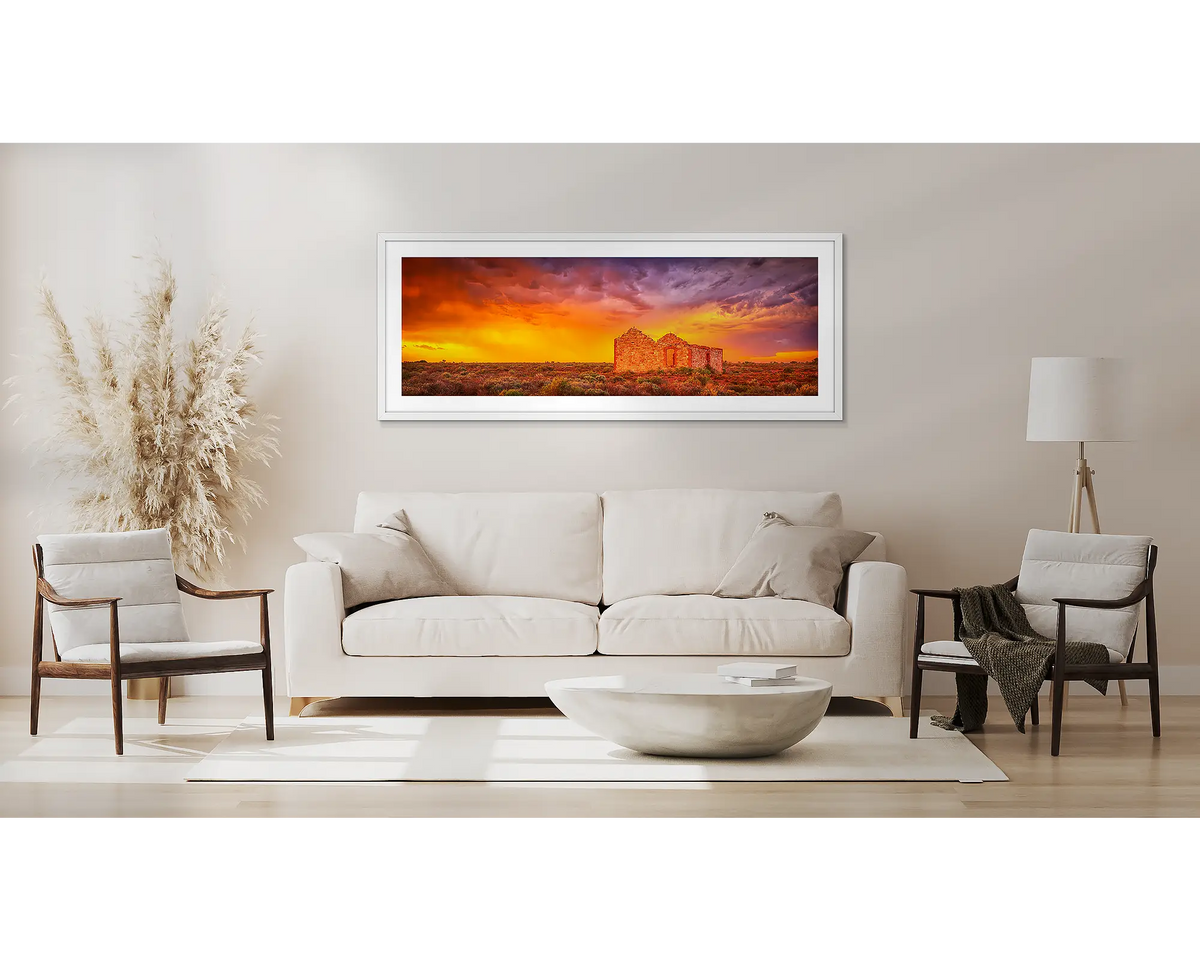 Pioneering Spirit. Flinders Ranges wall art in a white frame, above a couch.