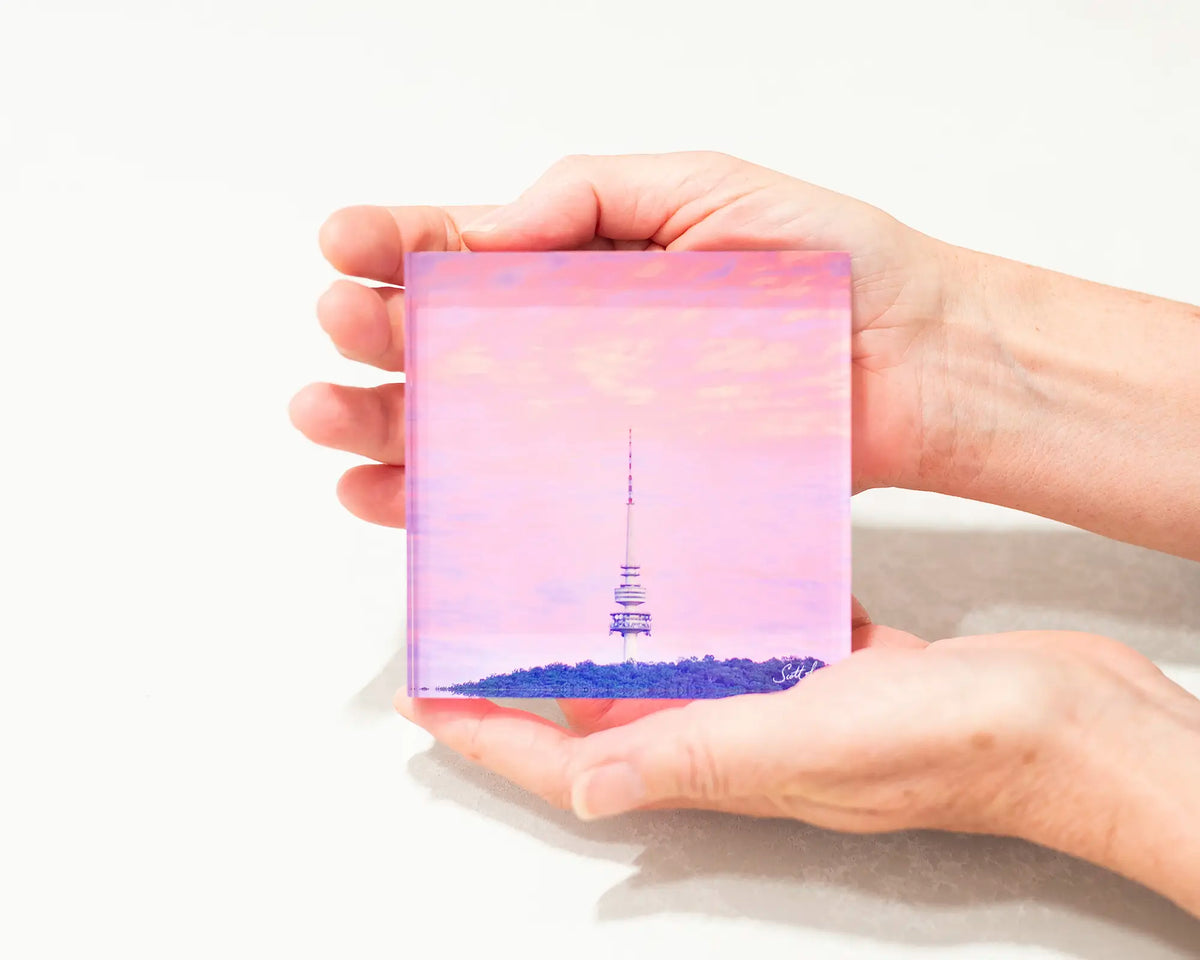 Pointer. Acrylic block of Telstra tower, Canberra artwork being held.