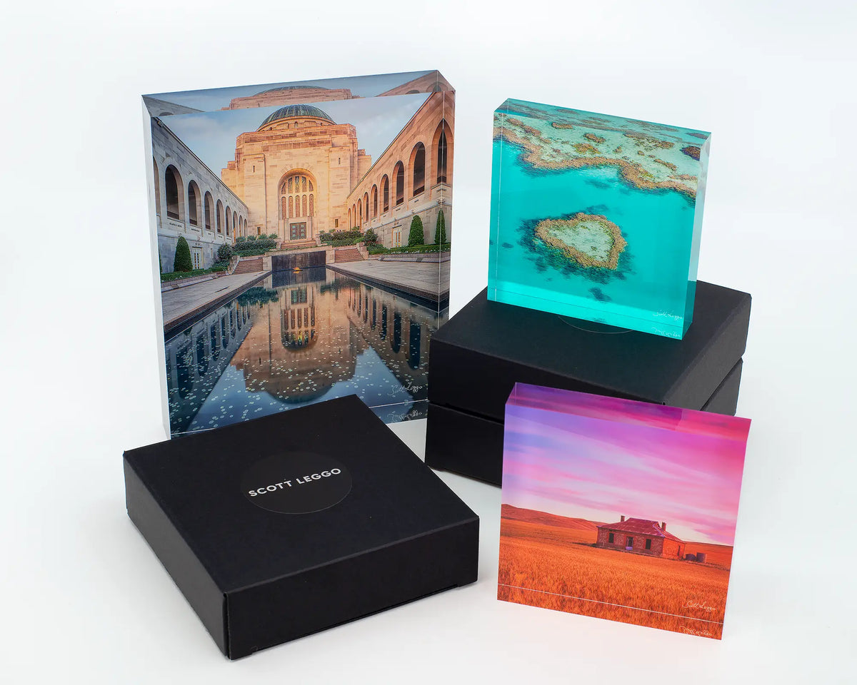 Pool of Reflection acrylic block displayed with other acrylic blocks and gift boxes.