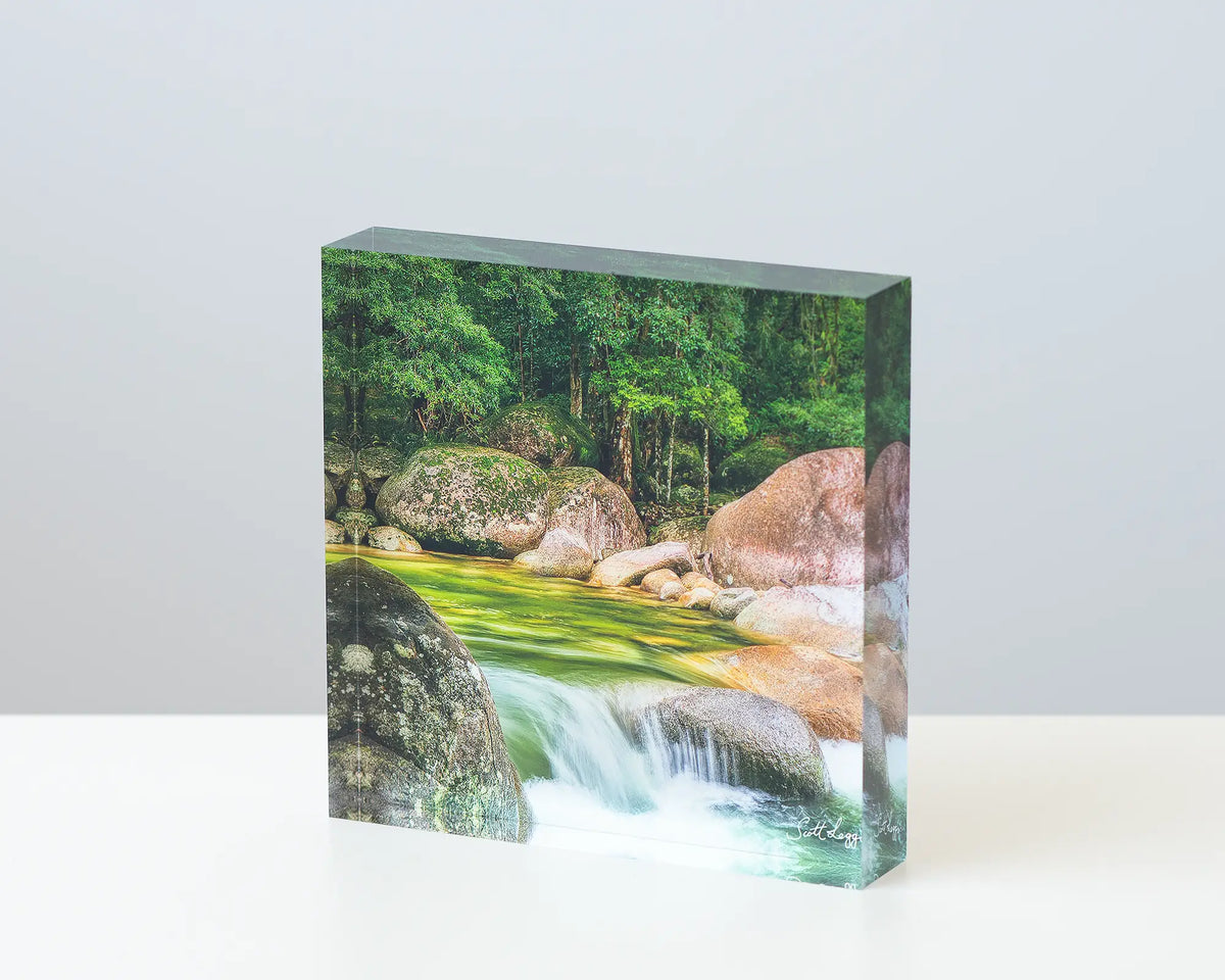Rainforest Rocks acrylic block displayed on a desk. 