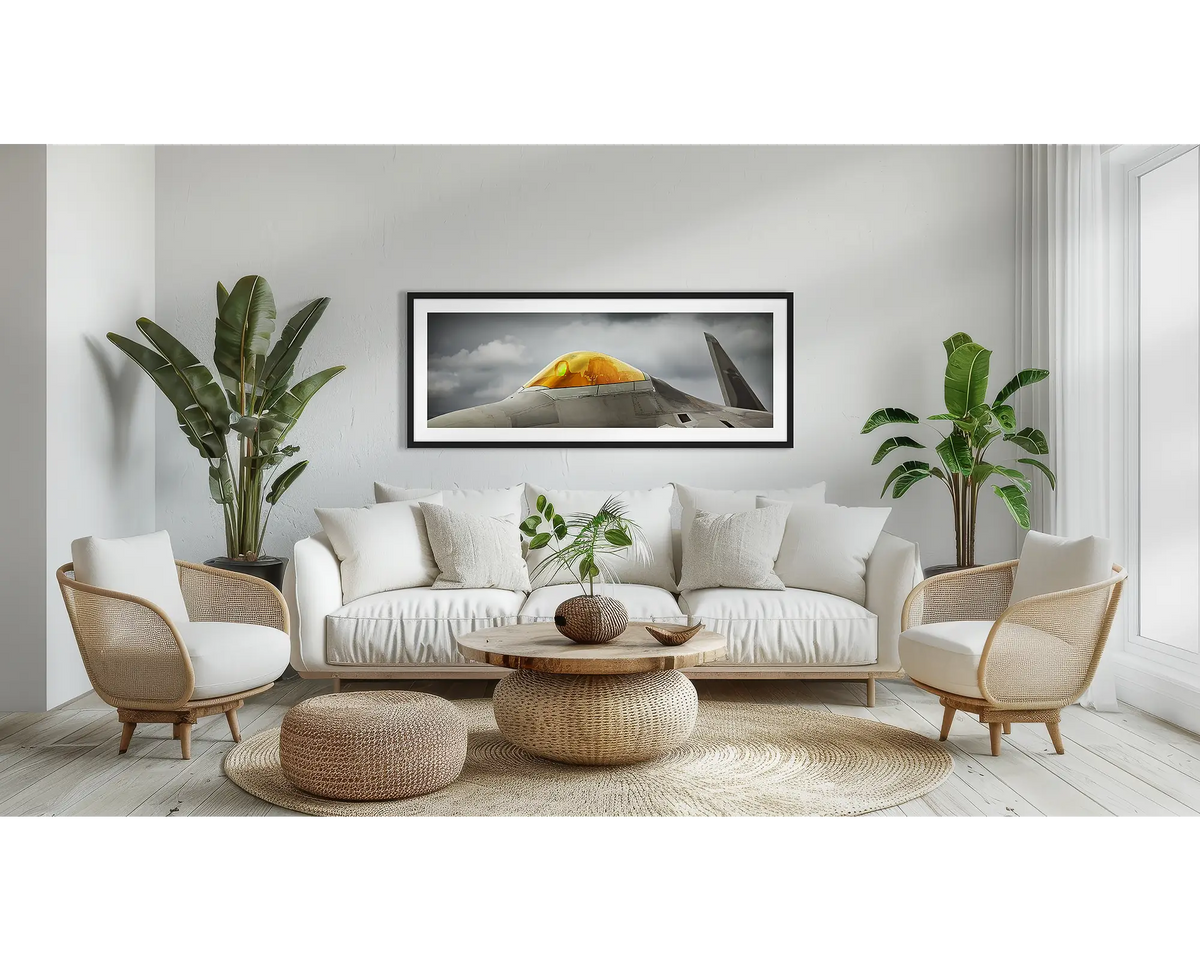 Raptor. F-22 aviation wall art print, with a black frame, above a couch. 