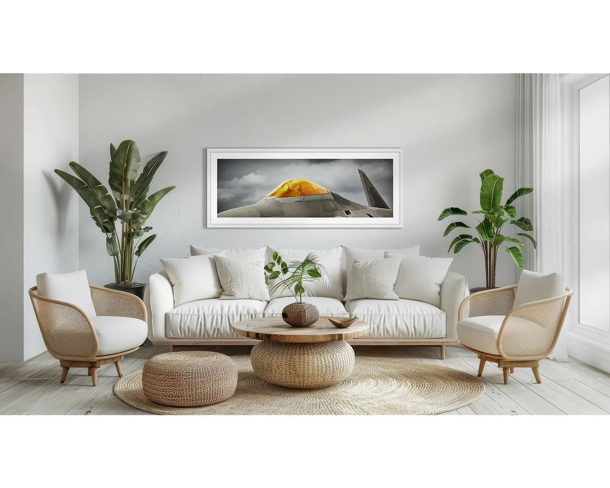 Raptor. F-22 aviation wall art print with a white frame, above a couch. 