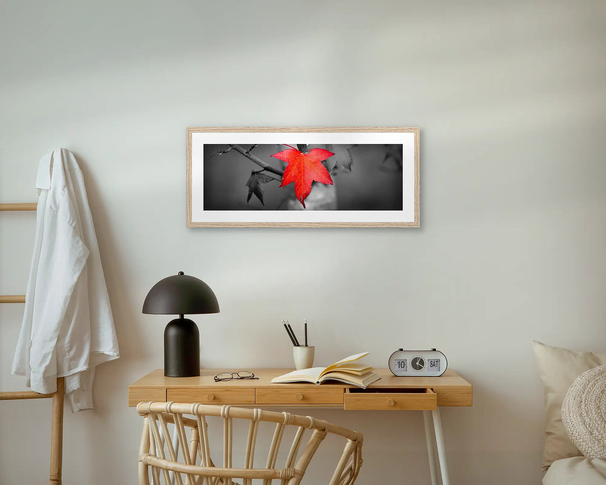 Red Leaf. Wall art print with a timber frame, hung above a small desk. 