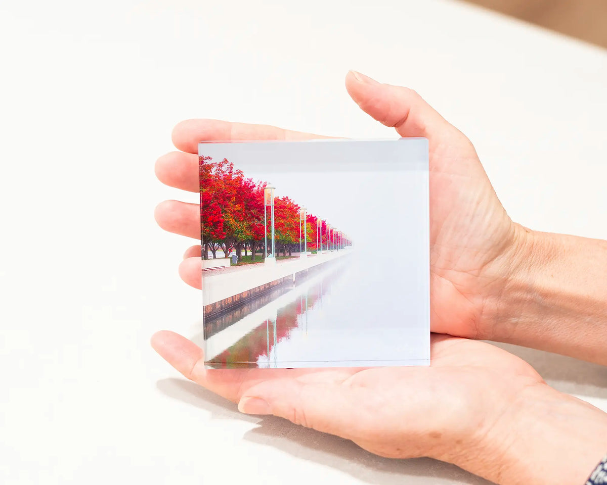 Red Serenity. Acrylic block of Lake Burley Griffin, Canberra artwork being held.