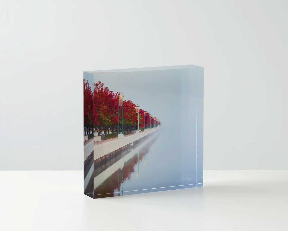 Red Serenity. Acrylic block Lake Burley Griffin, Canberra artwork on table.