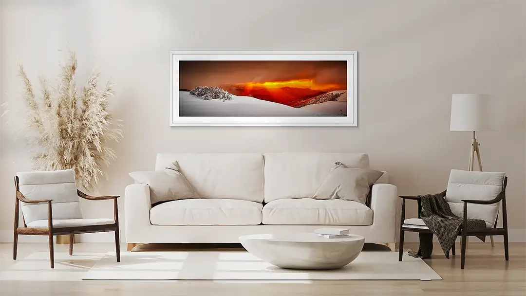 Red Wall art artwork in white frame above couch.