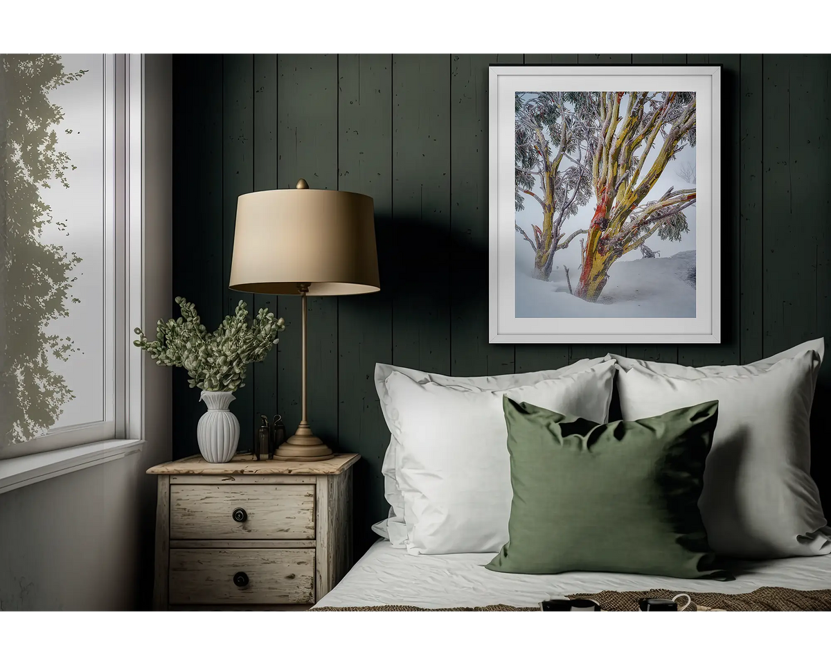 Resilience. Snow gum artwork in a white frame above a bed. 