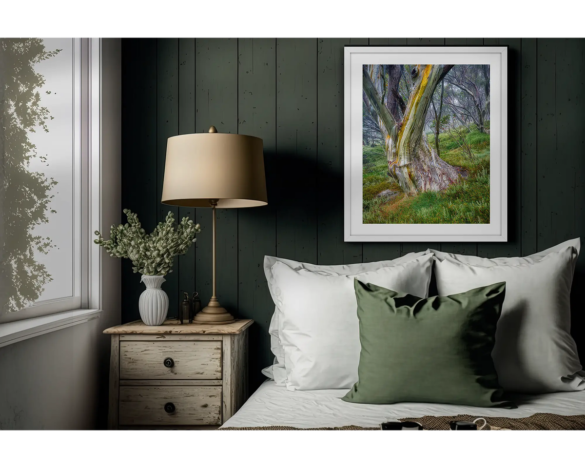 Resistance. Snow gum artwork in a white frame above a bed. 