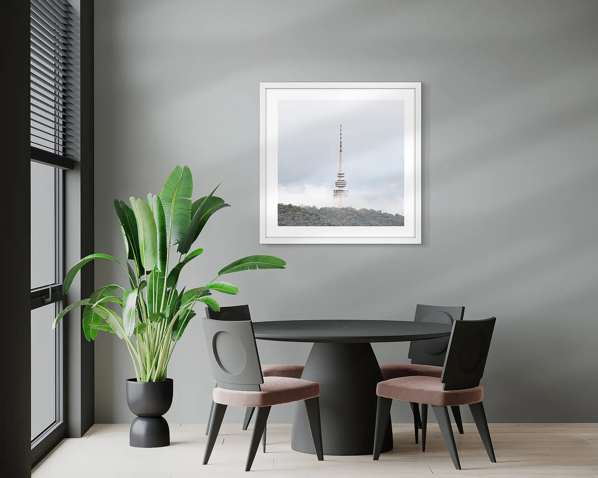 Rising. Black Mountain Tower artwork with a white frame, hung on the wall of an office meeting room. 