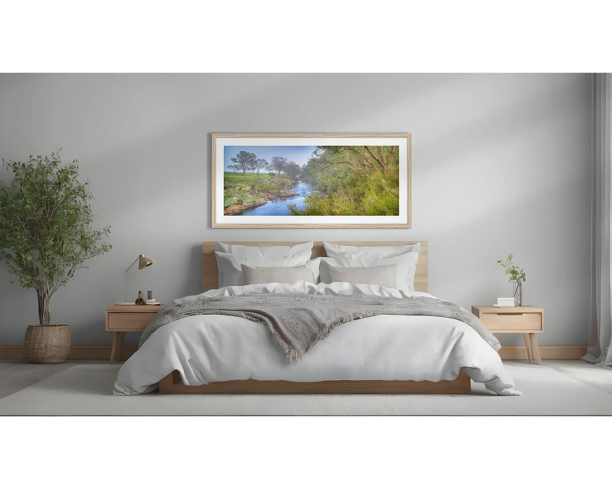 Riverside Veil. Murray River wall art framed in a Tasmanian Oak frame, hanging above a bed.