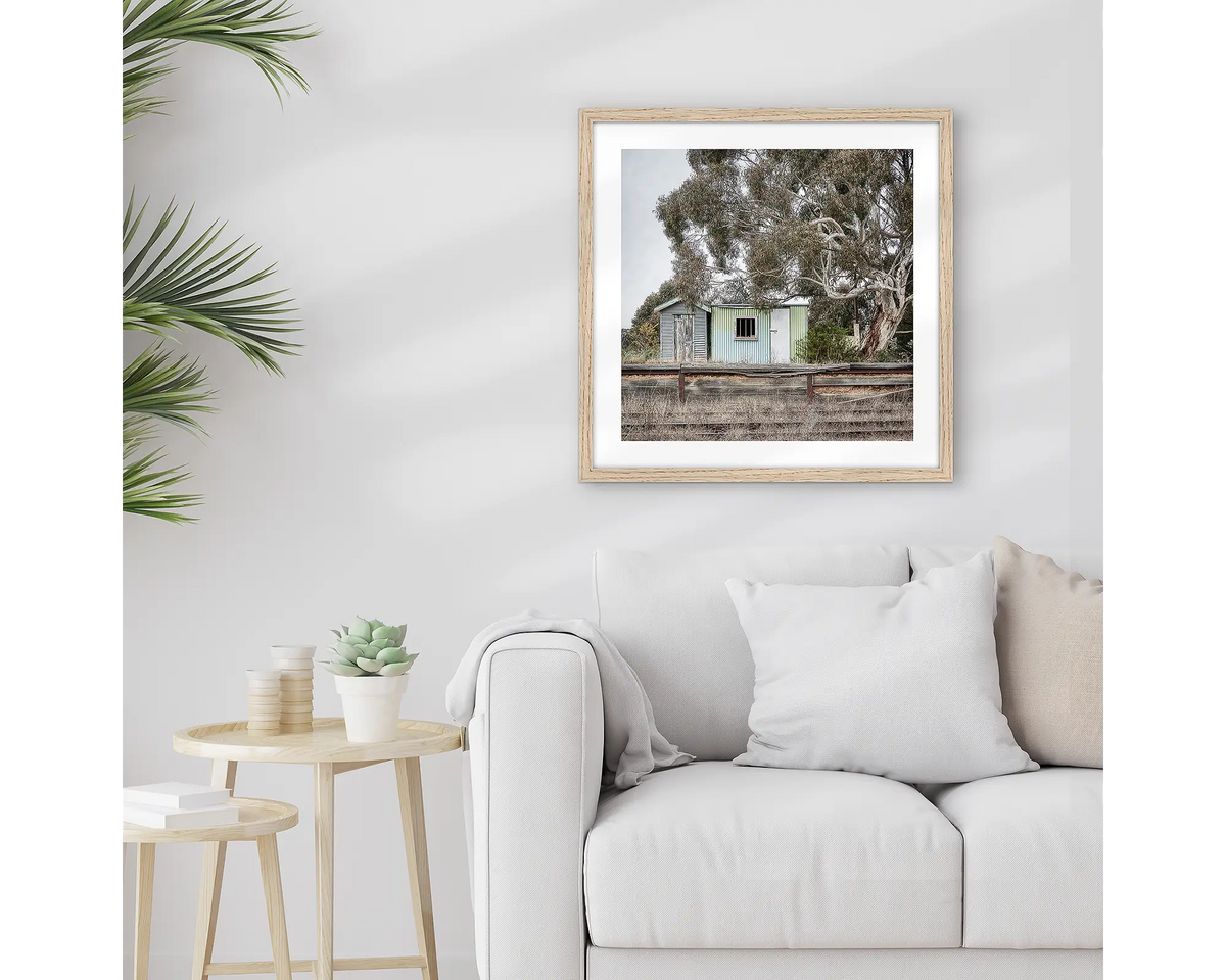 Royalla. Framed train station wall art print with a timber frame, hung above a couch.