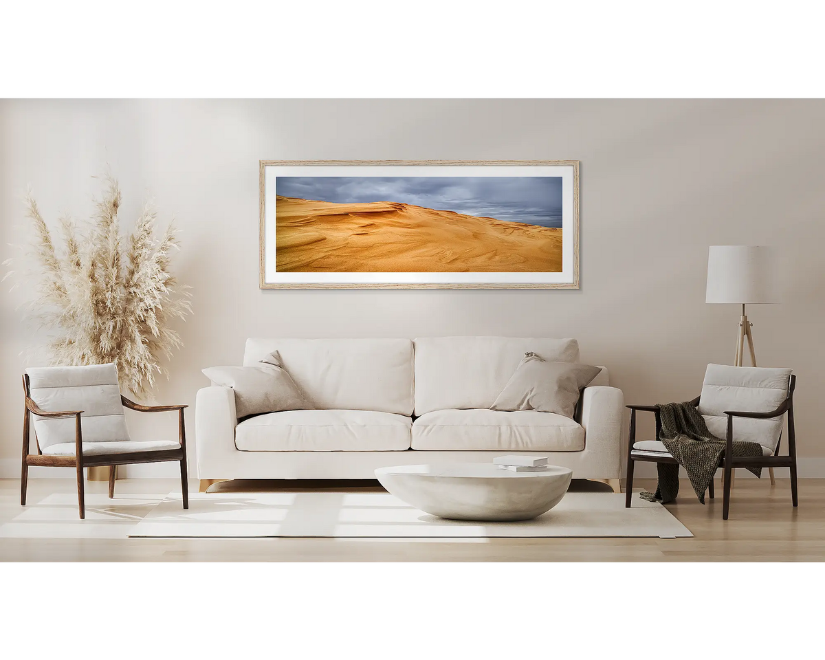 Sands of Time. Newcastle wall art, in a Tassie Oak frame, in a lounge room. 