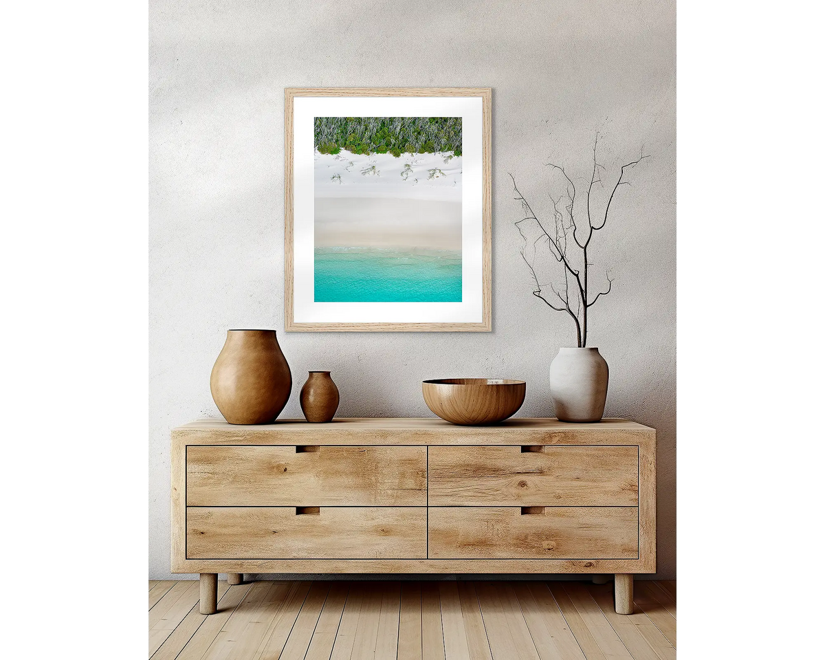 Sea Change. Framed coastal wall art hanging above a side table. 