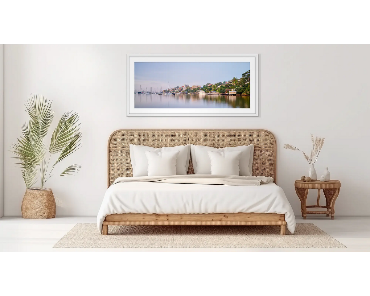 Seclusion. Sydney Harbour wall art in a white frame, on a bedroom wall. 