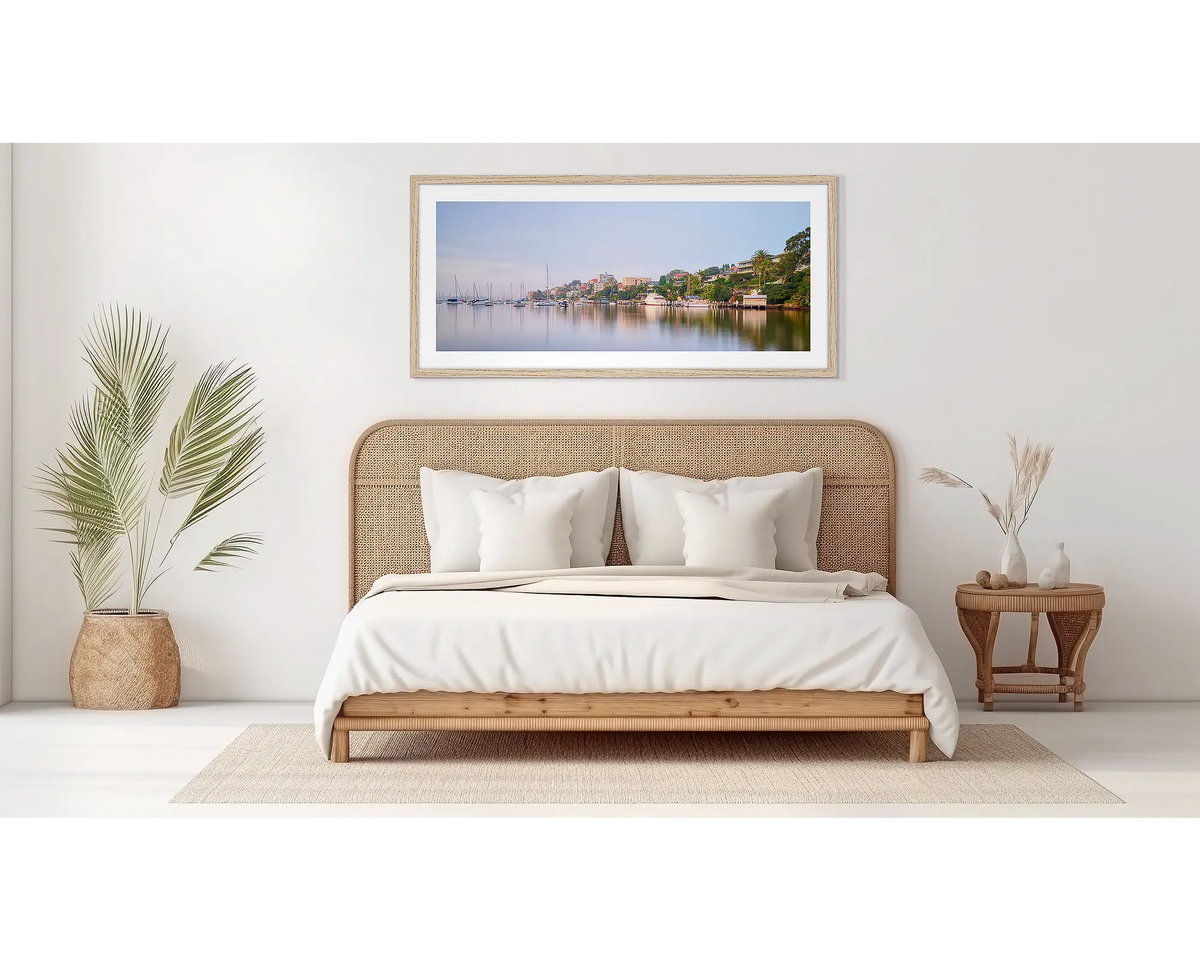 Seclusion. Sydney Harbour wall art in a wood frame, on a bedroom wall. 