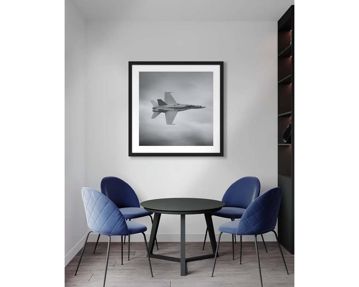 seek and Strike. F-18 Hornet aviation wall art print, with a black frame, in an office meeting room. 