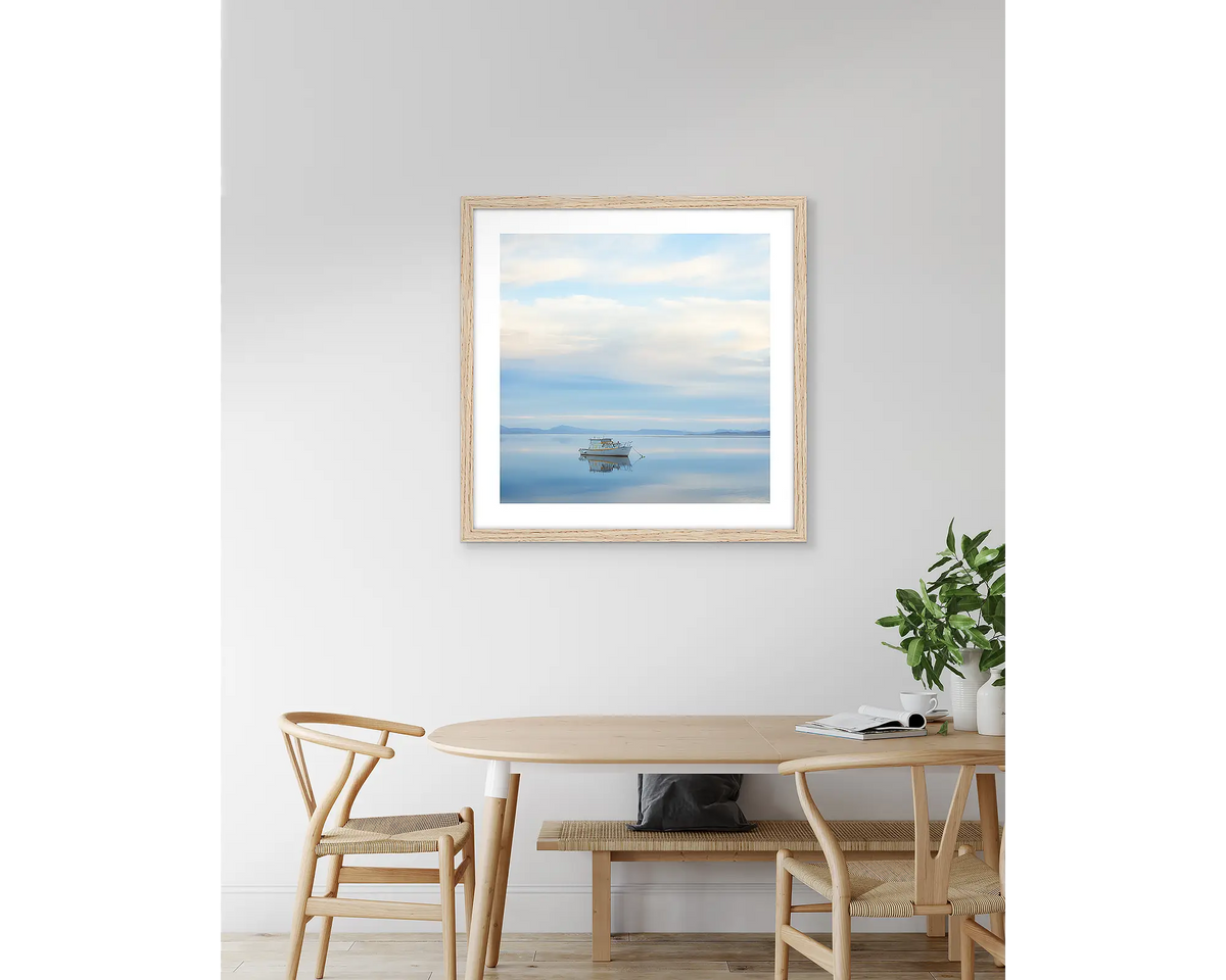 Serenity. Tasmanian artwork, with a timber frame, hung above a kitchen table.